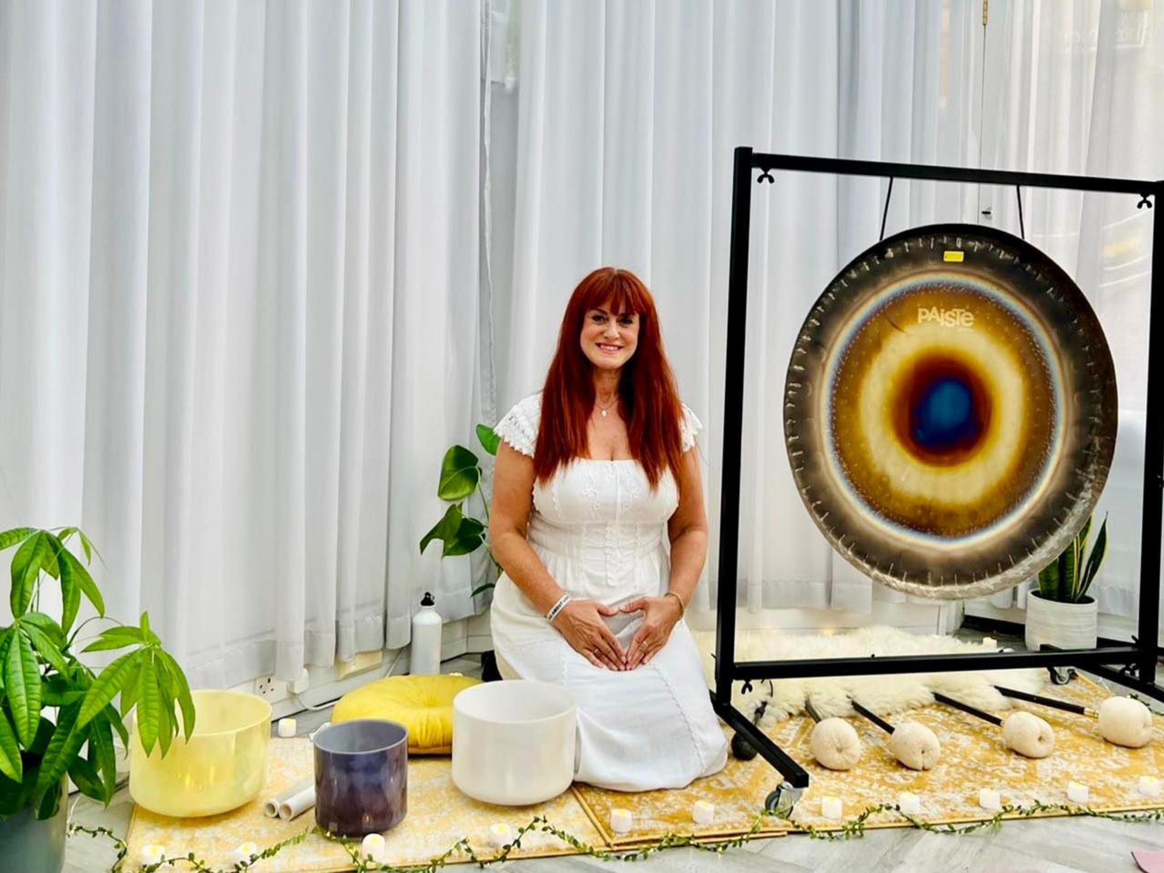 Image of Rachel with gong, bowls and drums ready for a sound healing gong immmersion session