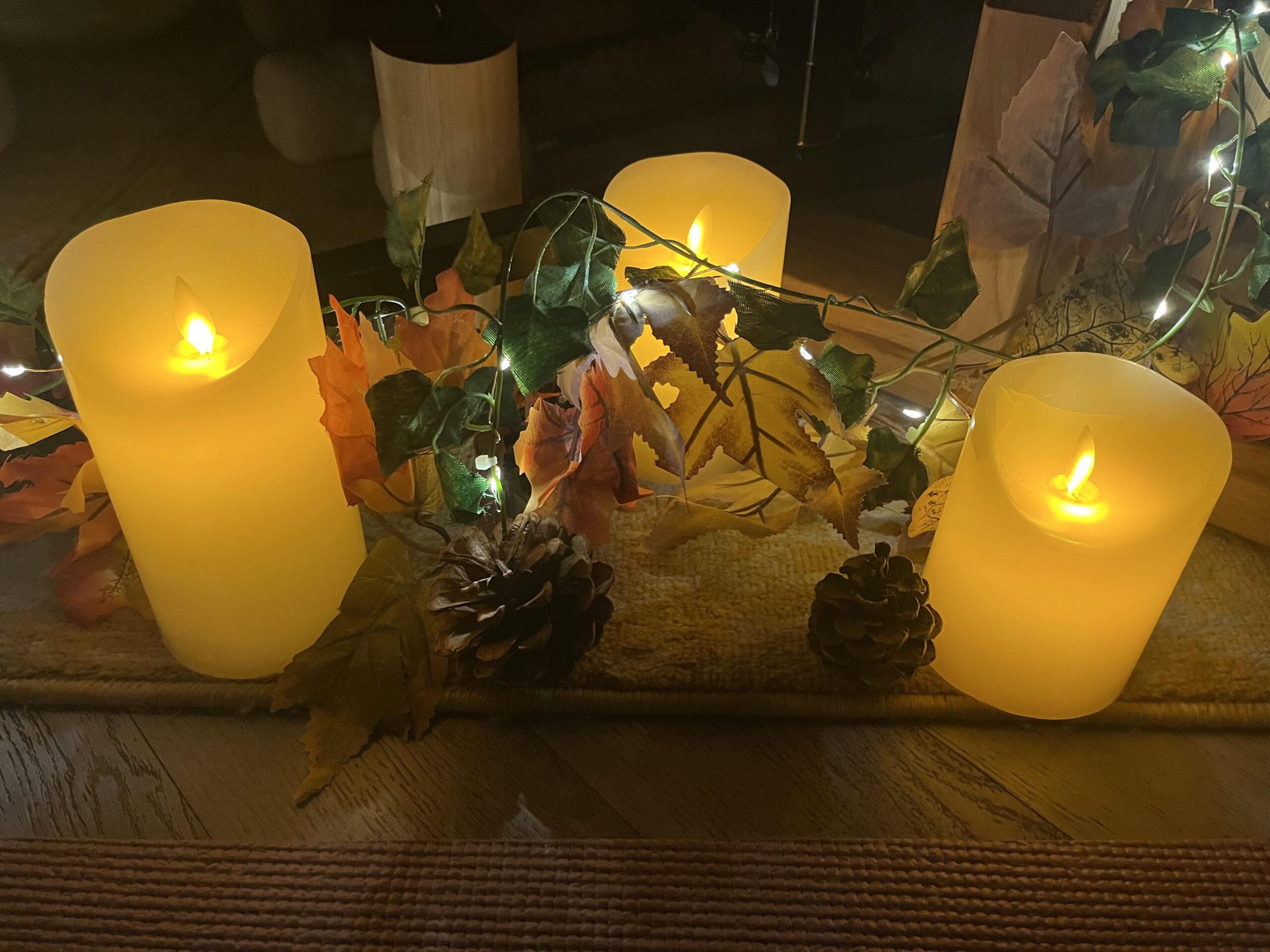 Image of candles surrounded with leaves with Autumn Sound Healing Sessions with Geet Fateh Kaur